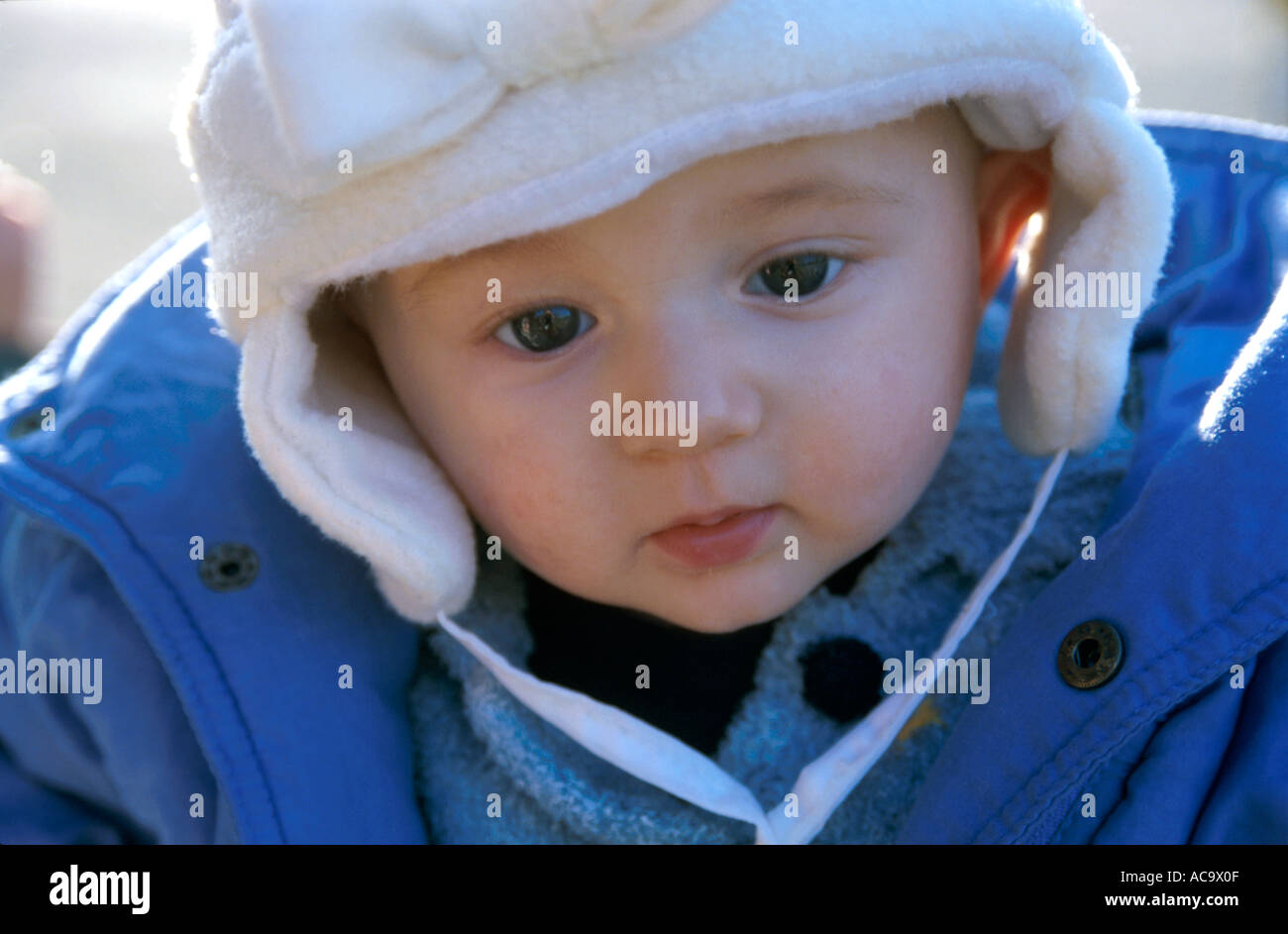 Baby girl wearing winter clothes outdoors, France. Stock Photo