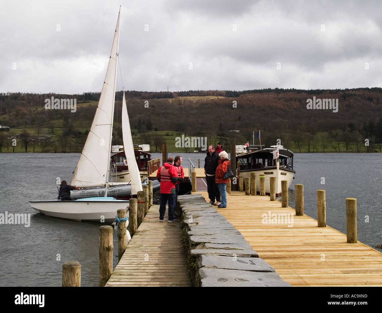 Boat landing jetty with sailing dinghy and motor launch at Coniston