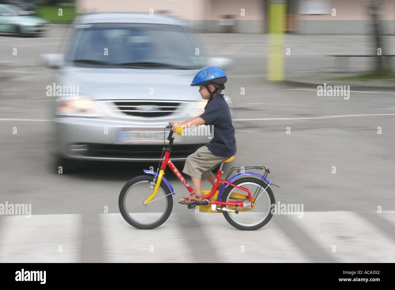 Child with a bicycle on pedestrian crossing Stock Photo