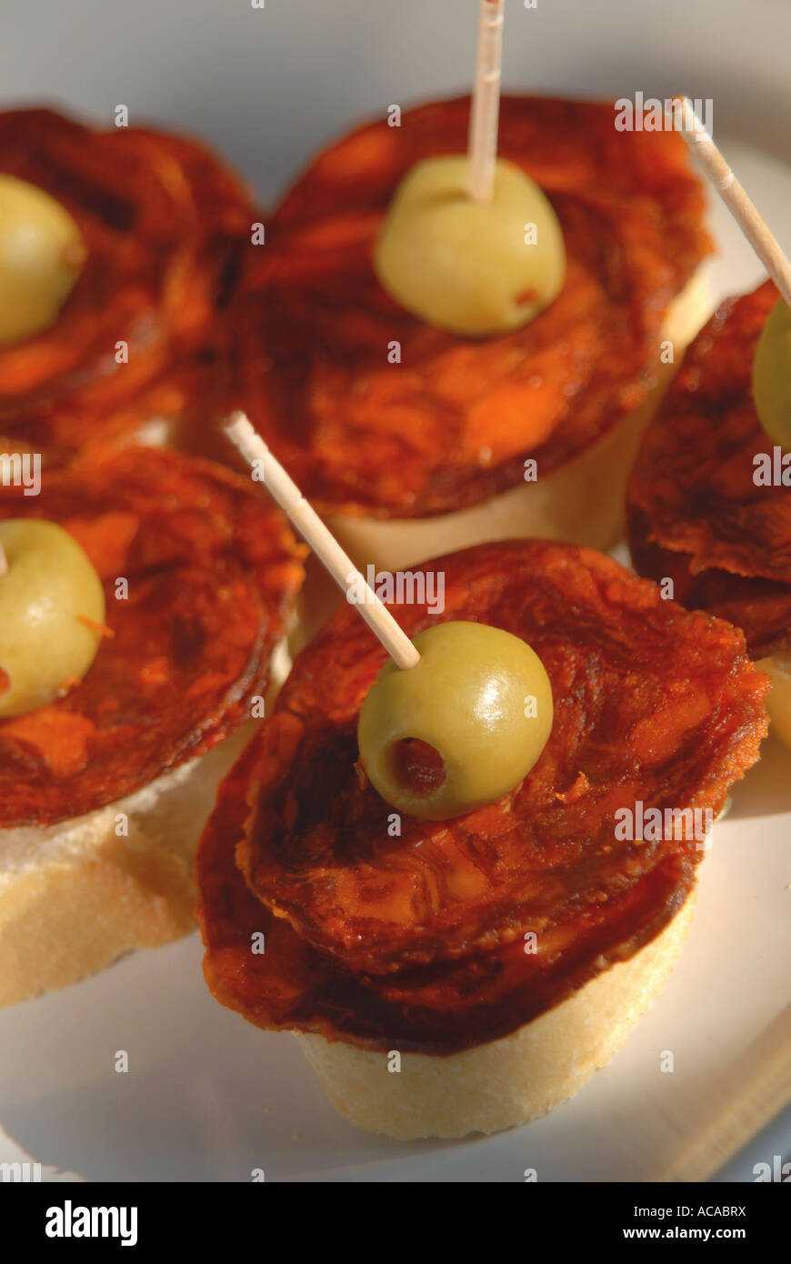 SPAIN Chorizo Iberico de Bellota and stuffed olives on bread Stock Photo