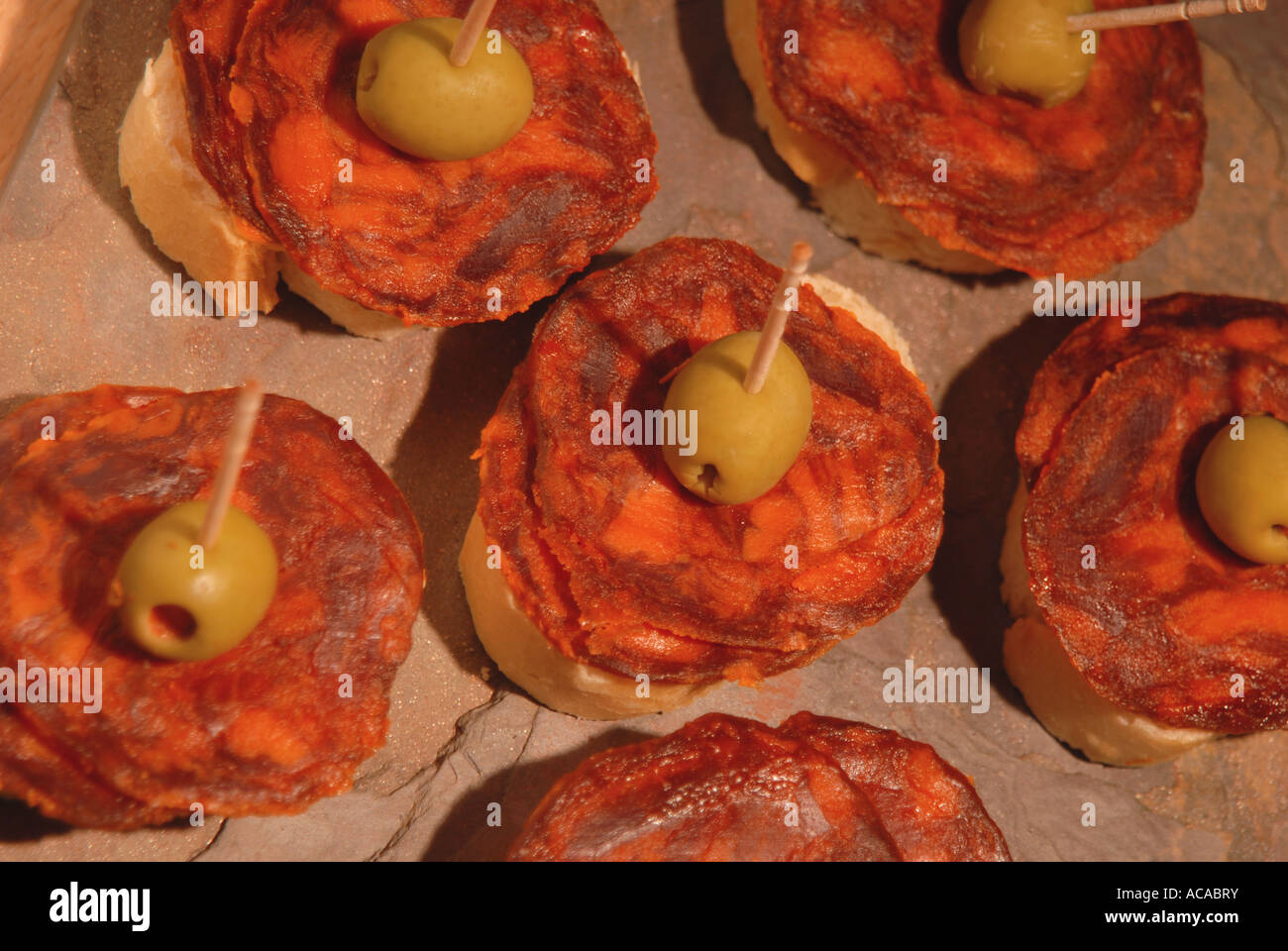 SPAIN Chorizo Iberico de Bellota and stuffed olives on bread Stock Photo