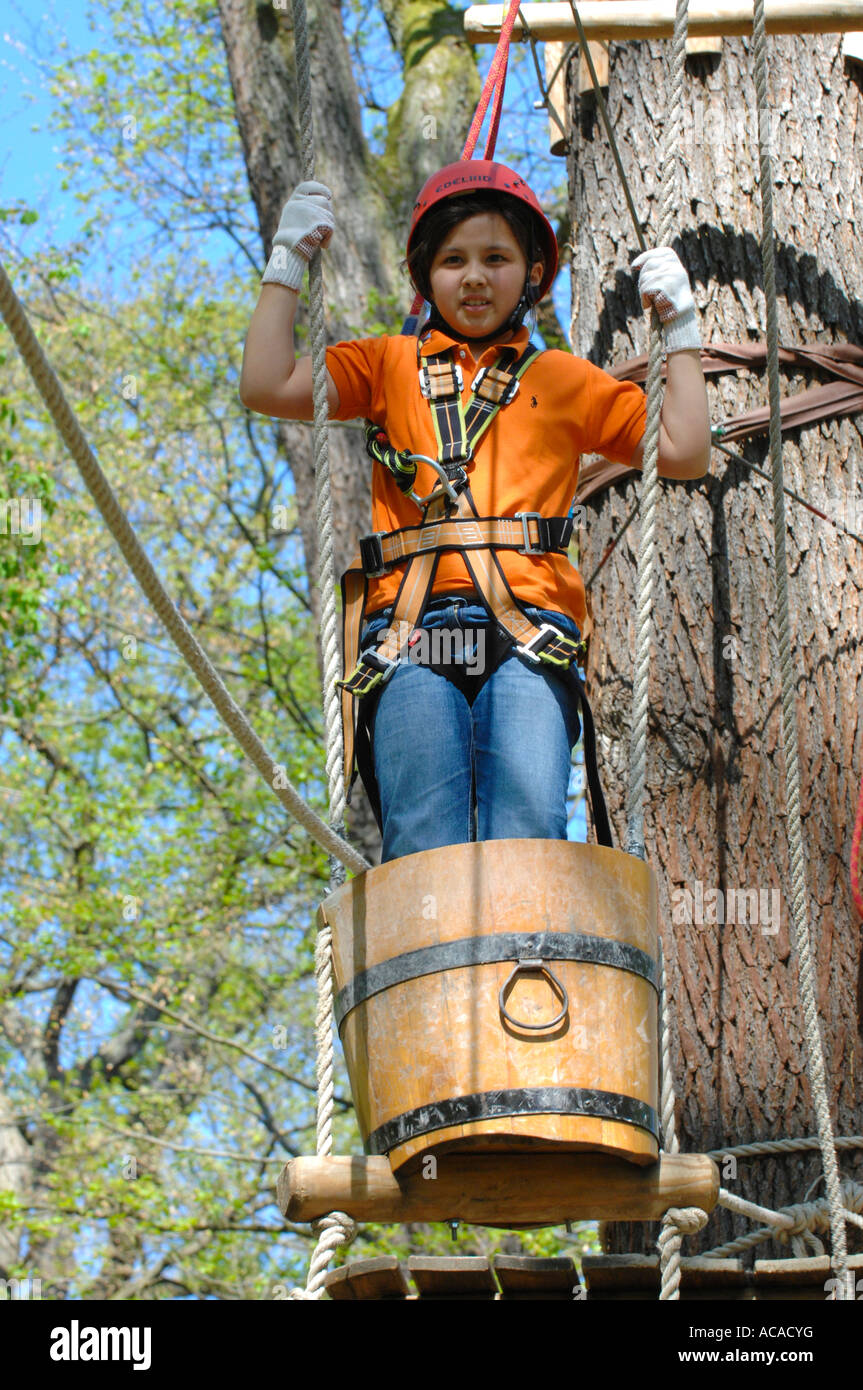 Girl with climbing equipment in a barrel, Climbing forest Neroberg