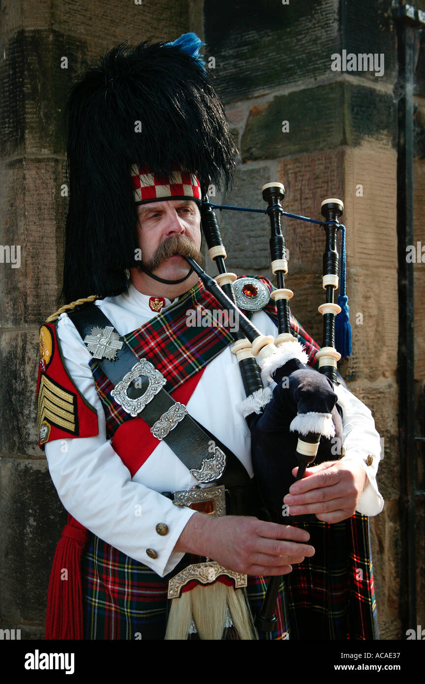 Scottish Piper with Bear Skin Hat playing the bagpipes (Editorial only use) Stock Photo