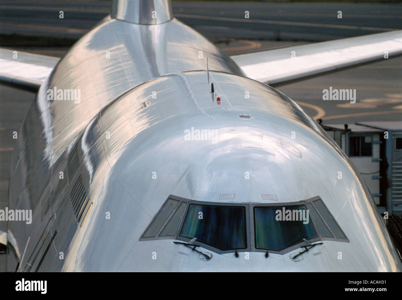 Boeing 747 jumbo jet parked at gate cockpit windows Stock Photo