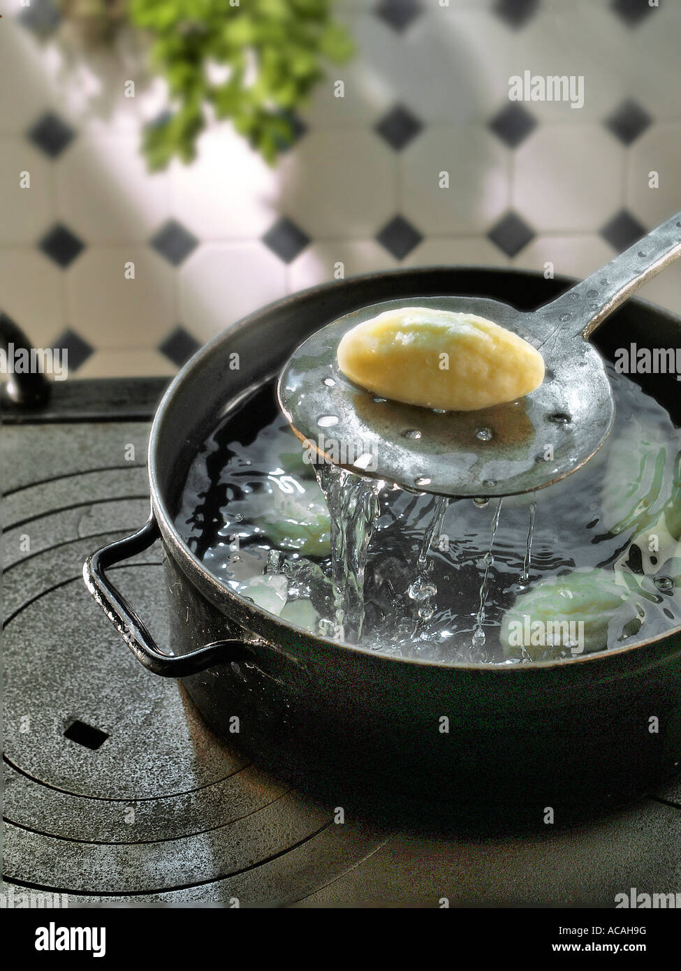 Semolina dumpling is singled out of the boiling water Stock Photo