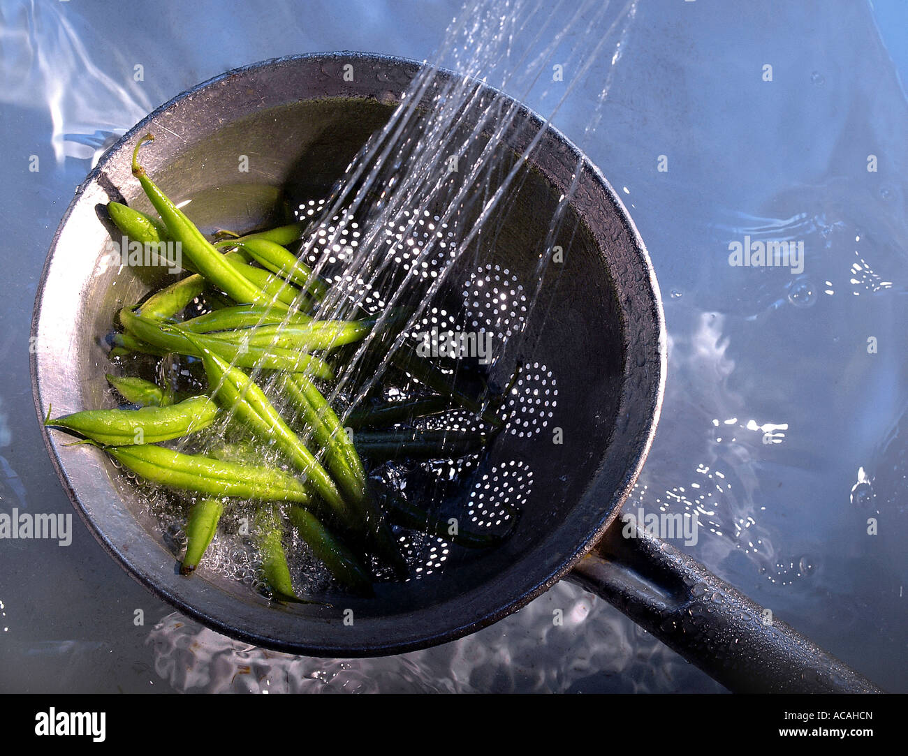 Common beans hosing down in a colander Stock Photo