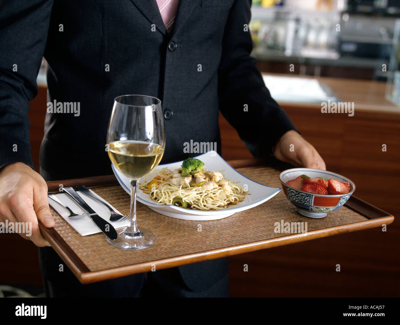 close up of man in suit carrying a tray in a self service restaurant