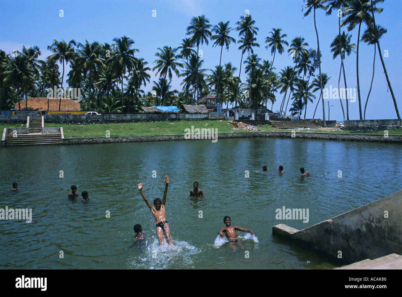 Boys swimming at Thirumullavaram Kerela India The Tsunami hit this area at a height of 15 metres  Stock Photo