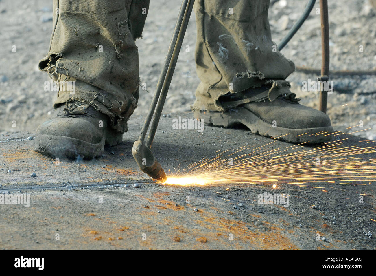 Closed down steel mill. Stripping down, Working with a cutting torch Stock Photo