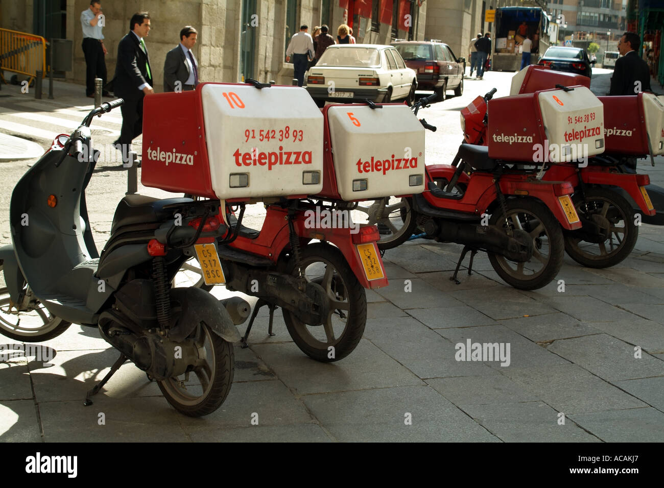pizza delivery motorcycles parked on the pavement. Madrid Spain Europe EU Stock Photo