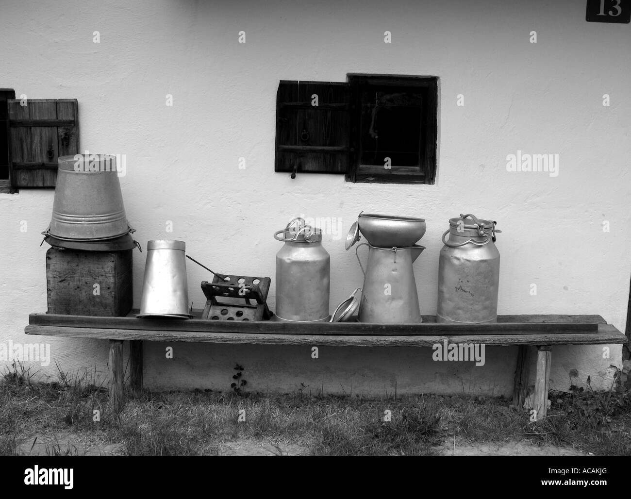 Milk jugs outside a farm, black and white Stock Photo