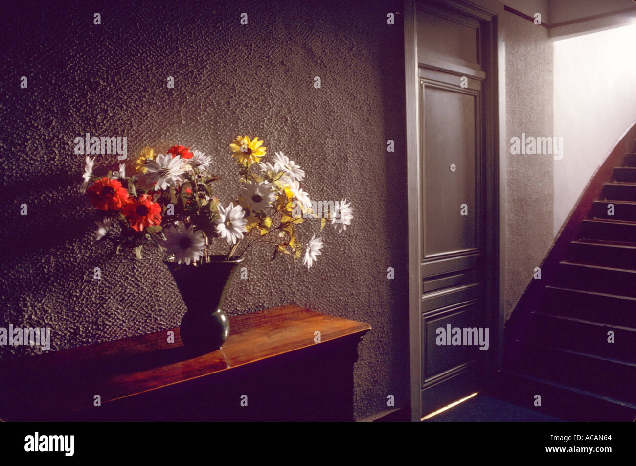 Arrangement of flowers on sideboard in hallway of french country hotel Stock Photo