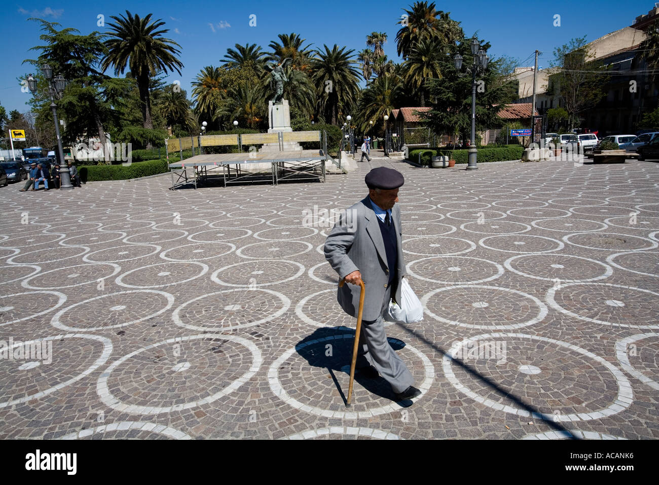 Old man crossing the main square in Corleone Palermo Sicily Italy Stock Photo