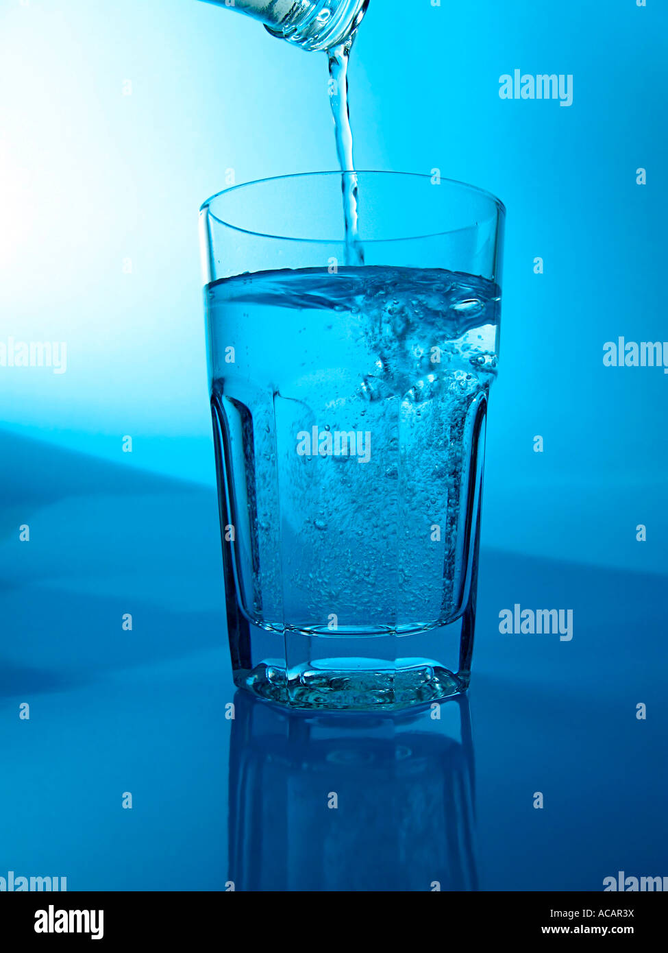 Pouring mineral water in a glass Stock Photo