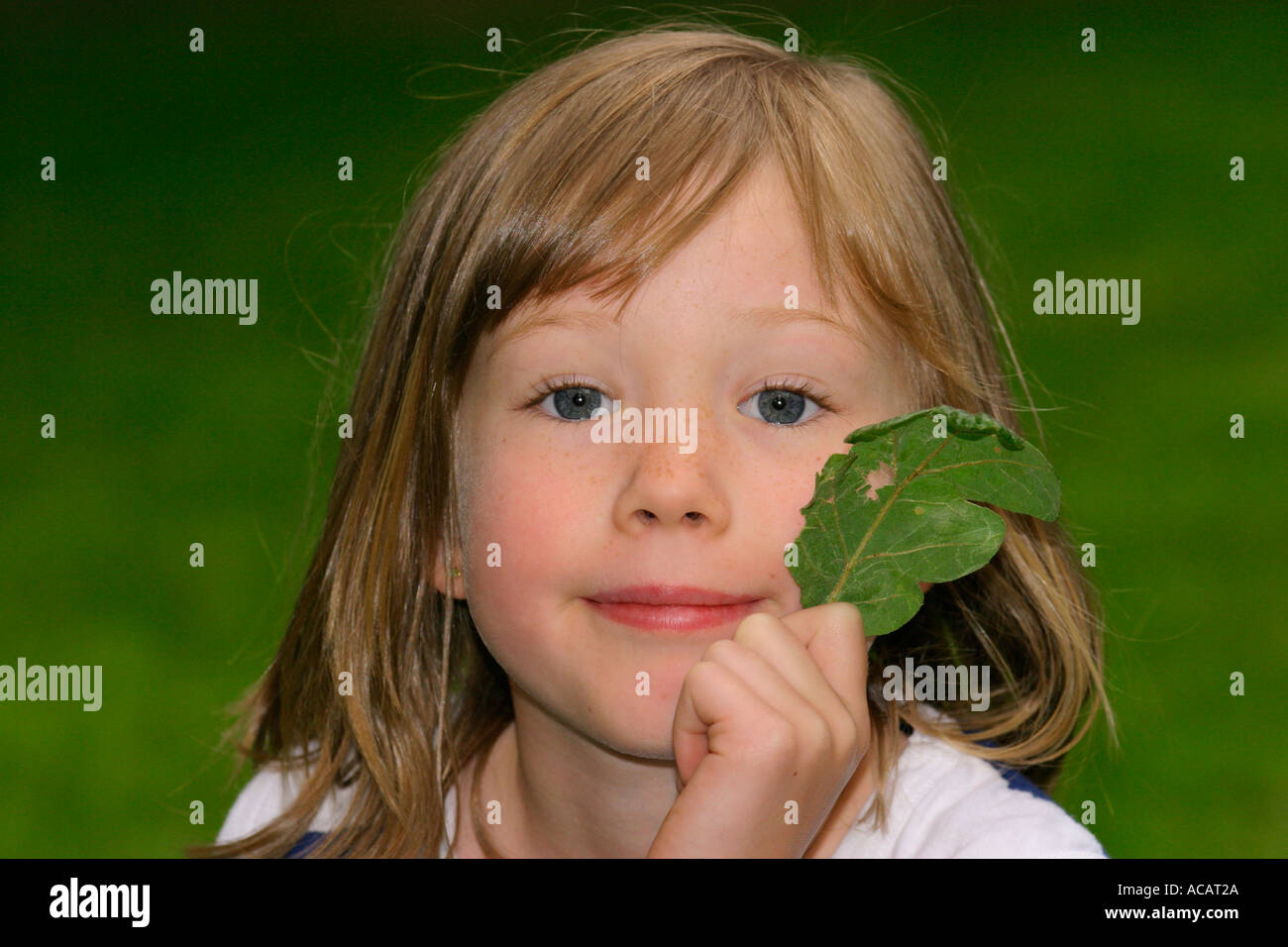 Portrait of young six year old girl with leaf Stock Photo - Alamy