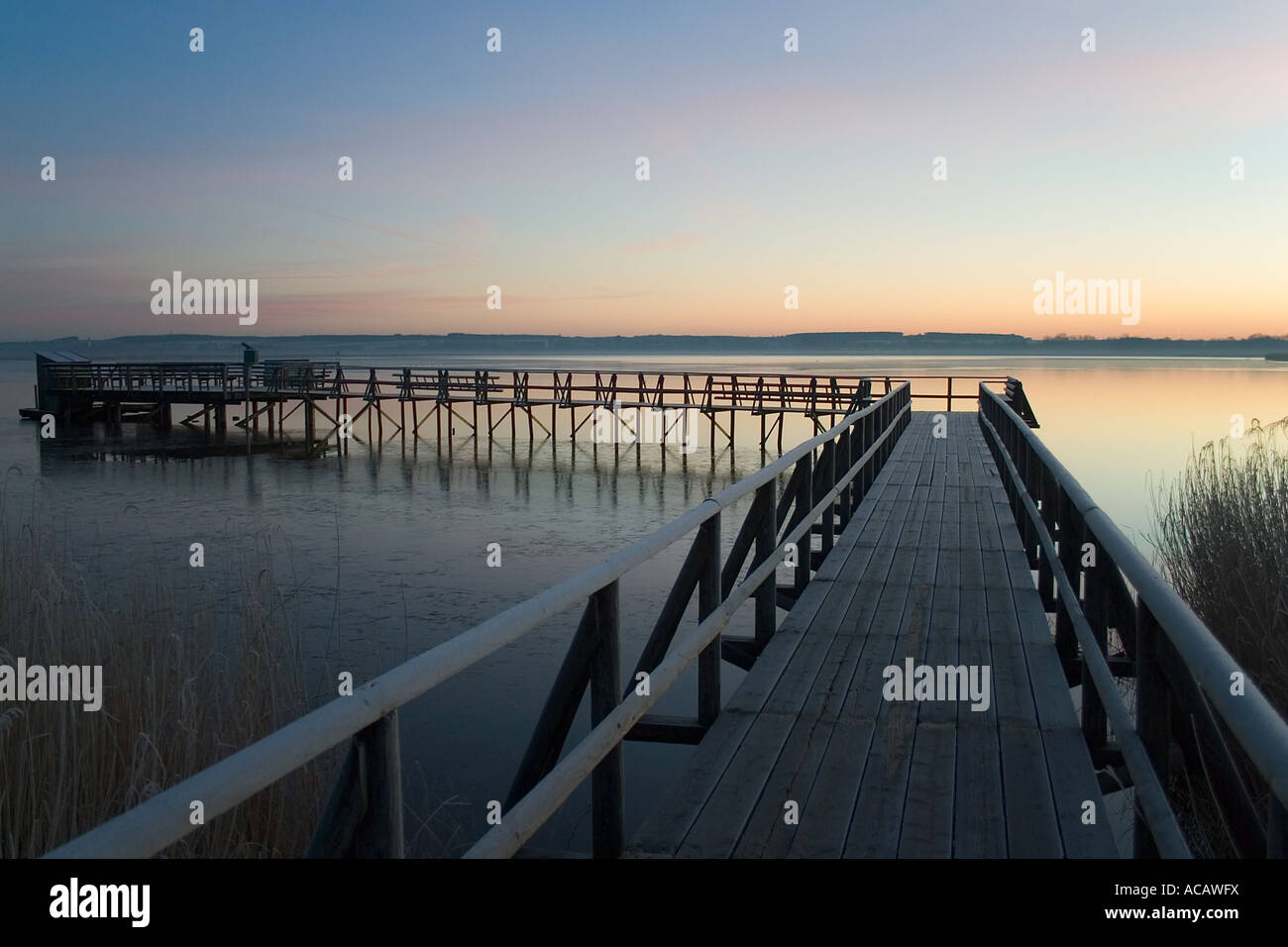 Sunrise at Feder lake footbridge, shot near Bad Buchau, Oberschwaben, Baden-Wuerttemberg, Germany Stock Photo