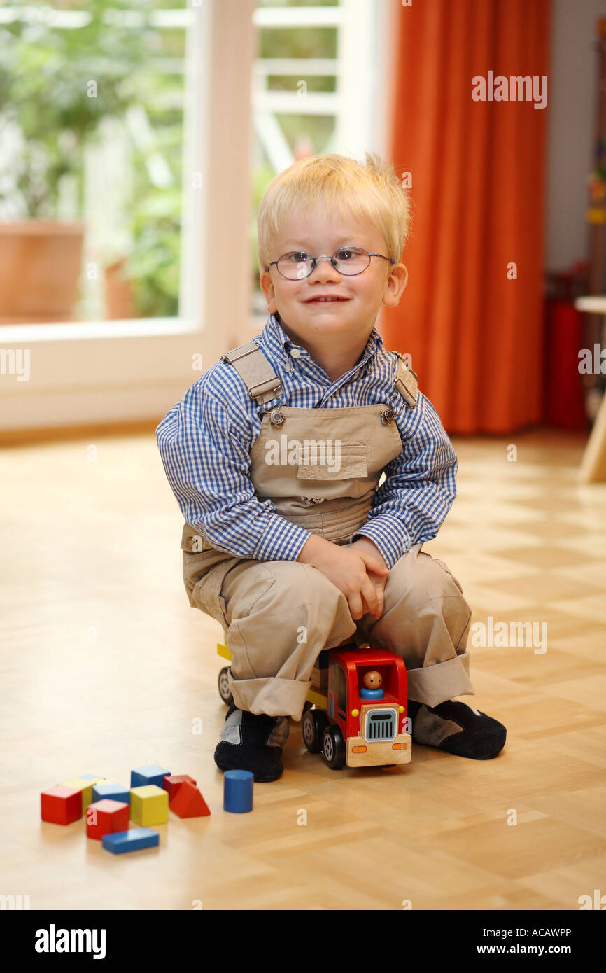 Little boy plays with a toy car Stock Photo