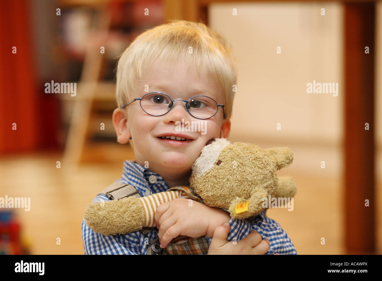 Little boy hugs his teddy bear, Strabismus Stock Photo