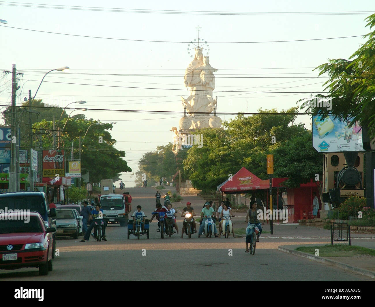 Street scene at oversized Maddona statue at sunset, Voncepcion, Paraguay Stock Photo
