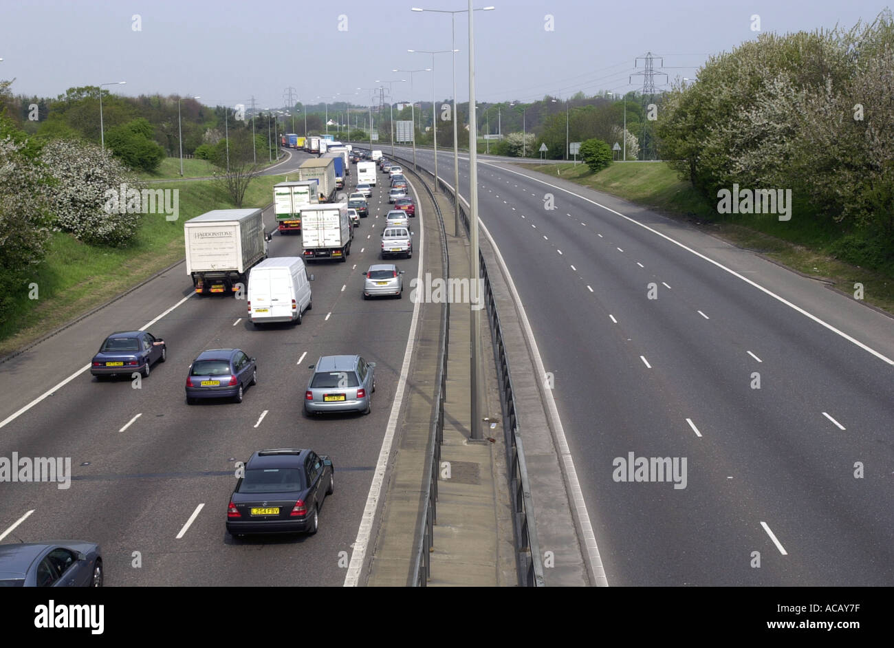 Heavy traffic on the M1 motorway northbound with few cars on the opposite carriageway uk Stock Photo