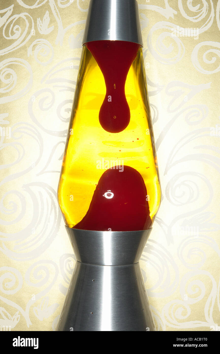 Yellow and red lava lamp against gold background Stock Photo