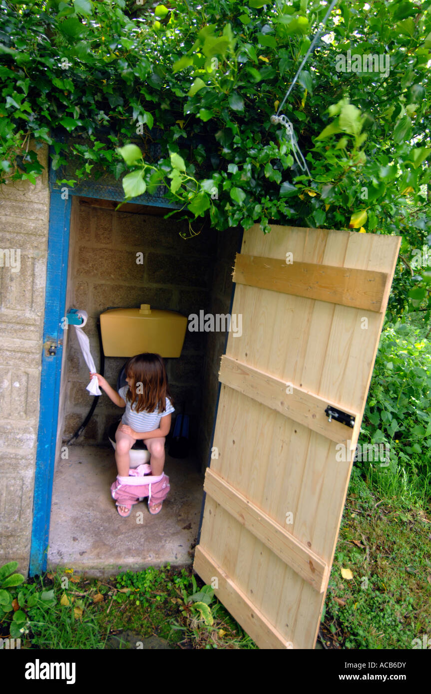 Toilet, Outside toilet, girl using an outdoor toilet Stock Photo