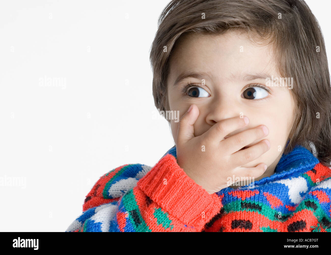 Closeup of a boy covering his mouth with his hands Stock Photo Alamy