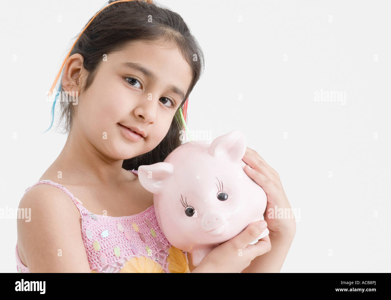 Portrait of a girl holding a piggy bank Stock Photo - Alamy