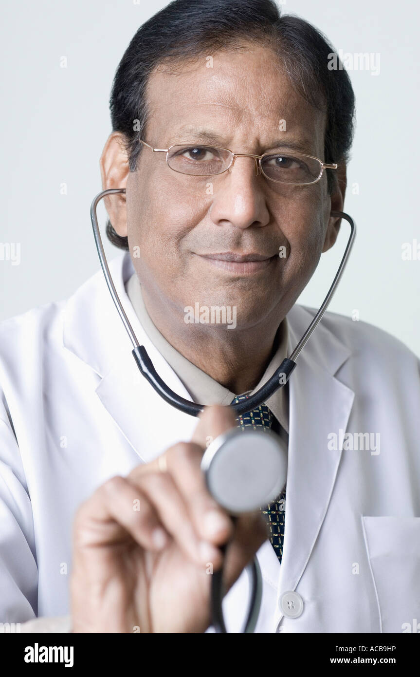 Portrait of a male doctor holding a stethoscope Stock Photo - Alamy