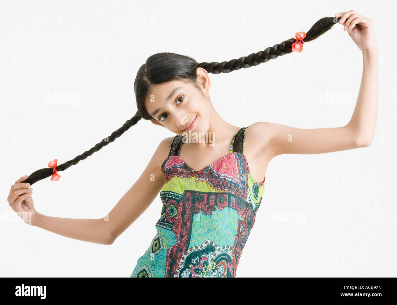 Portrait of a girl holding her braids Stock Photo - Alamy
