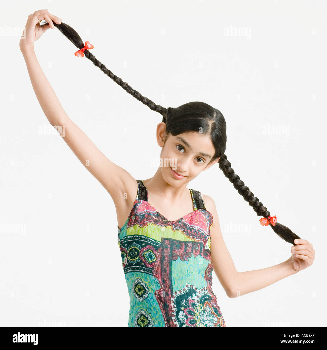 Portrait of a girl holding her braids Stock Photo - Alamy