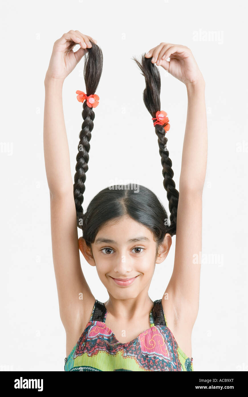Portrait of a girl holding her braids Stock Photo - Alamy