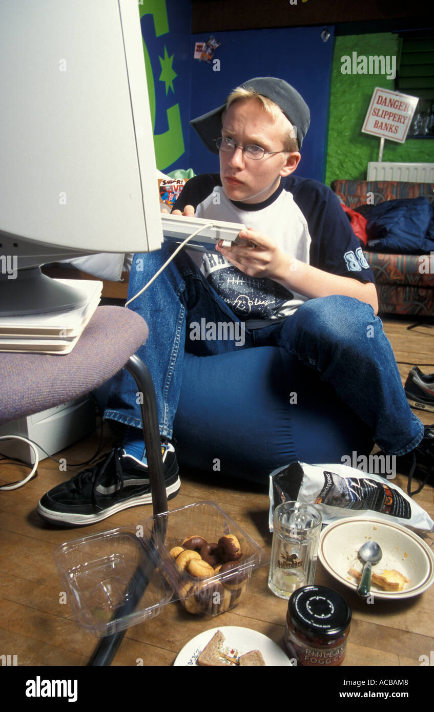 Teenage boy computer "nerd" playing on his computer Stock Photo