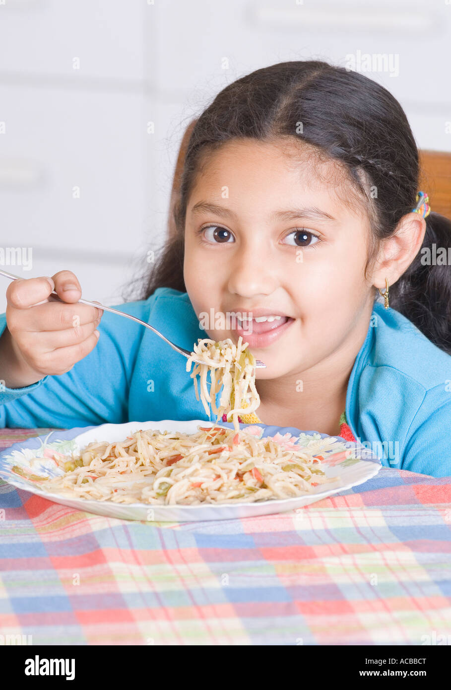 Portrait of a girl eating spaghetti with a fork Stock Photo Alamy