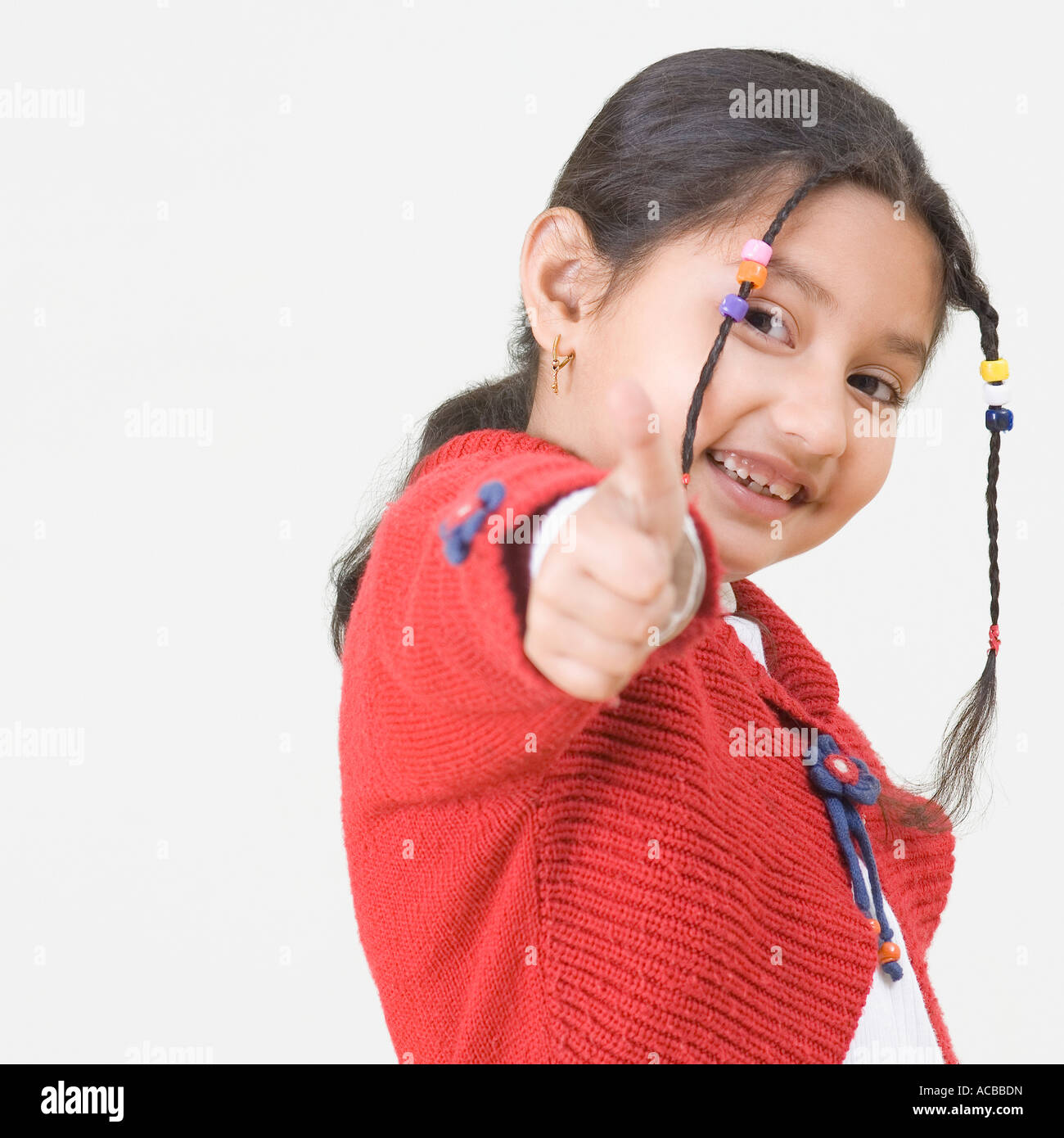 Portrait of a girl showing a thumb up sign Stock Photo - Alamy