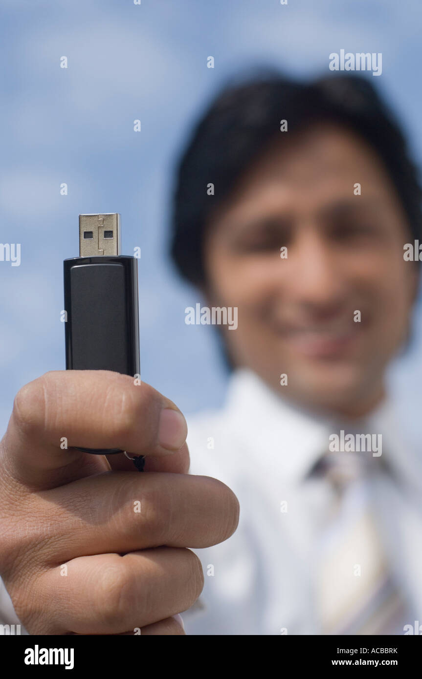 Portrait of a businessman holding a USB pen drive Stock Photo