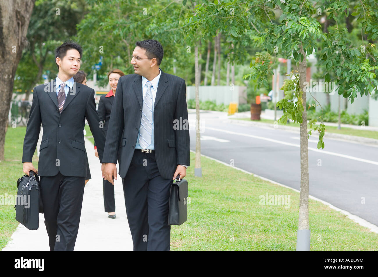 Two businessmen looking at each other and walking Stock Photo - Alamy