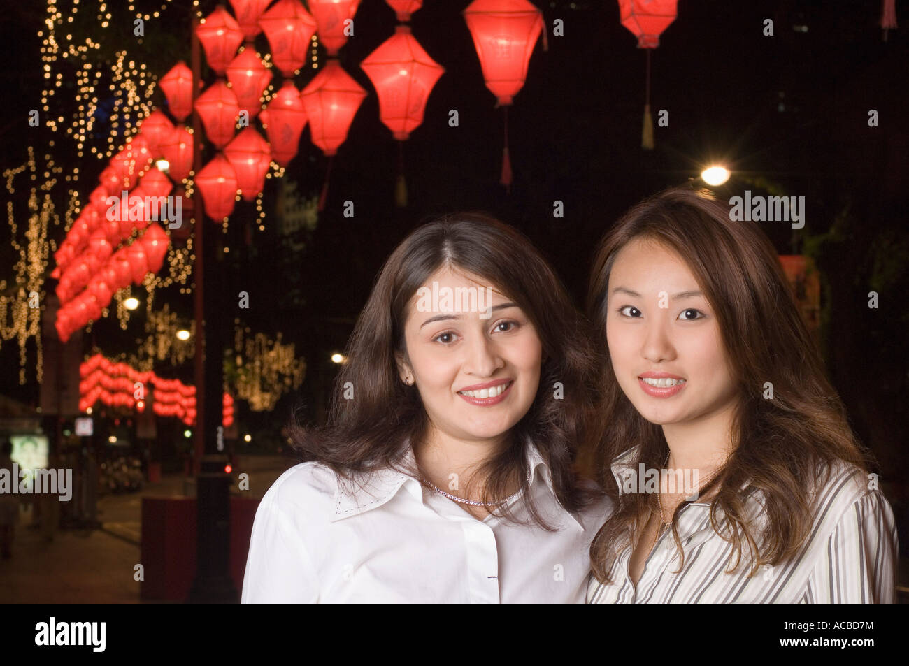 Portrait of two young women smiling Stock Photo - Alamy