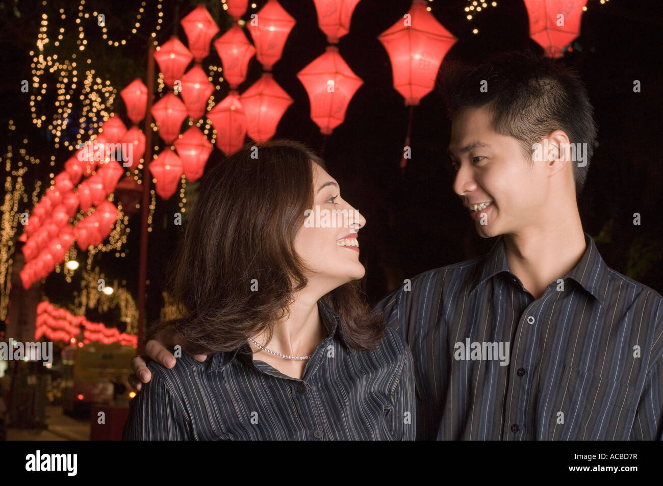 Young couple looking at each other and smiling Stock Photo - Alamy