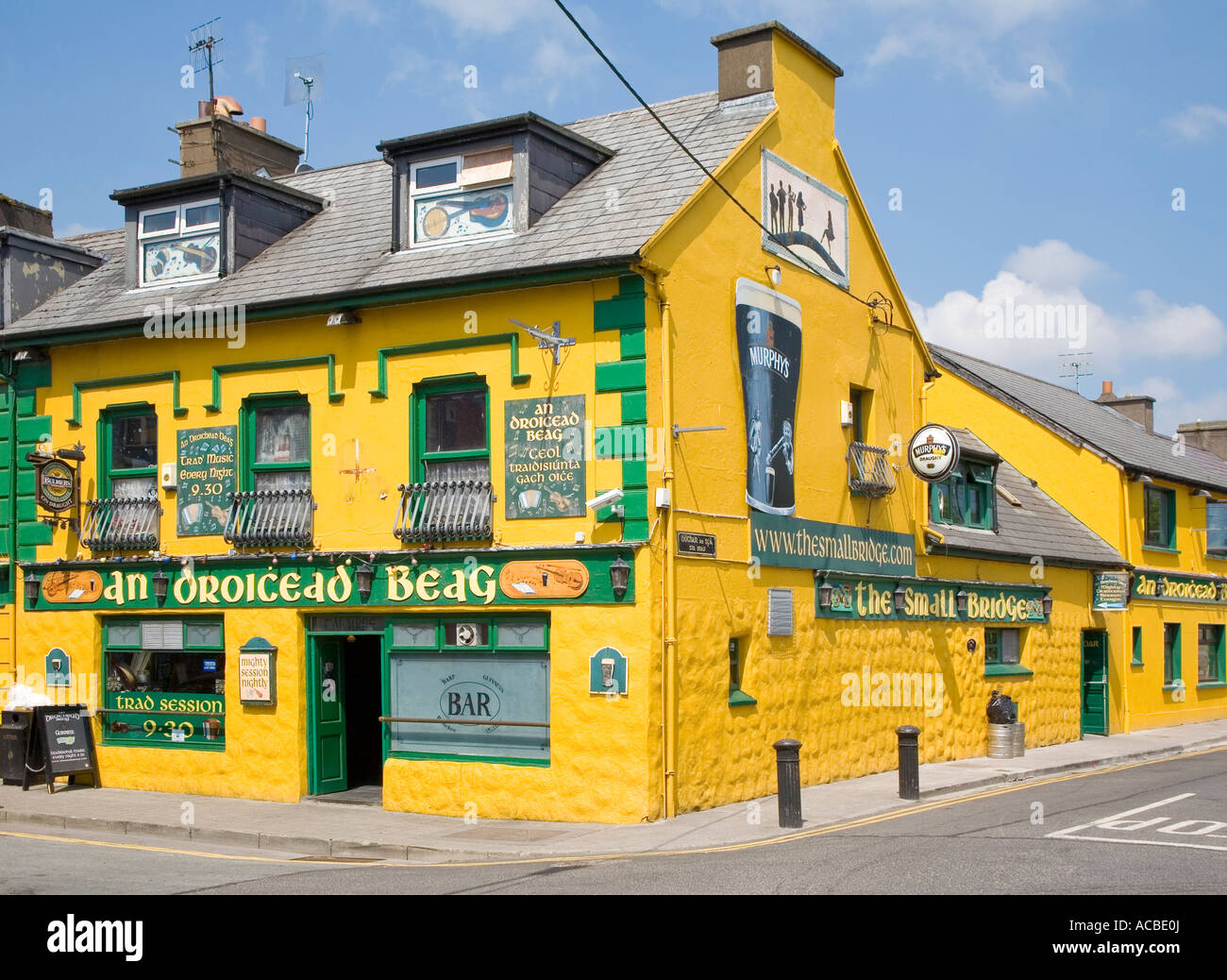 Bright yellow pub at the junction of Main street and Spa road Dingle Stock Photo