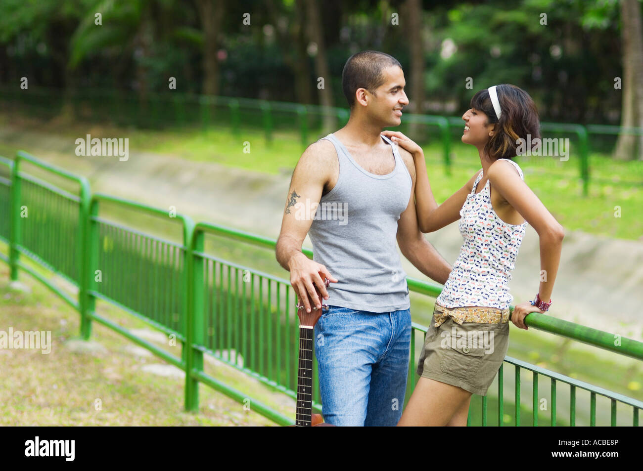 Mid adult woman and a young man looking at each other and smiling Stock ...