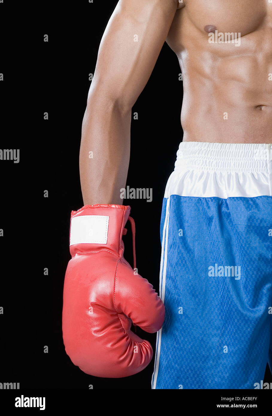 Mid section view of a boxer wearing a boxing glove Stock Photo
