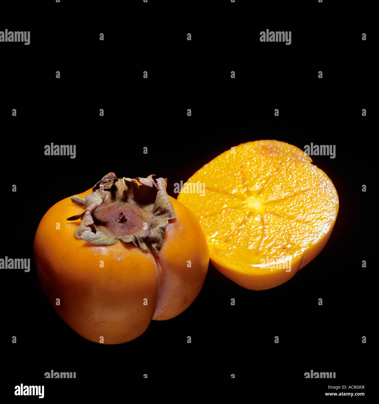 half of prickly kaki fruit Stock Photo