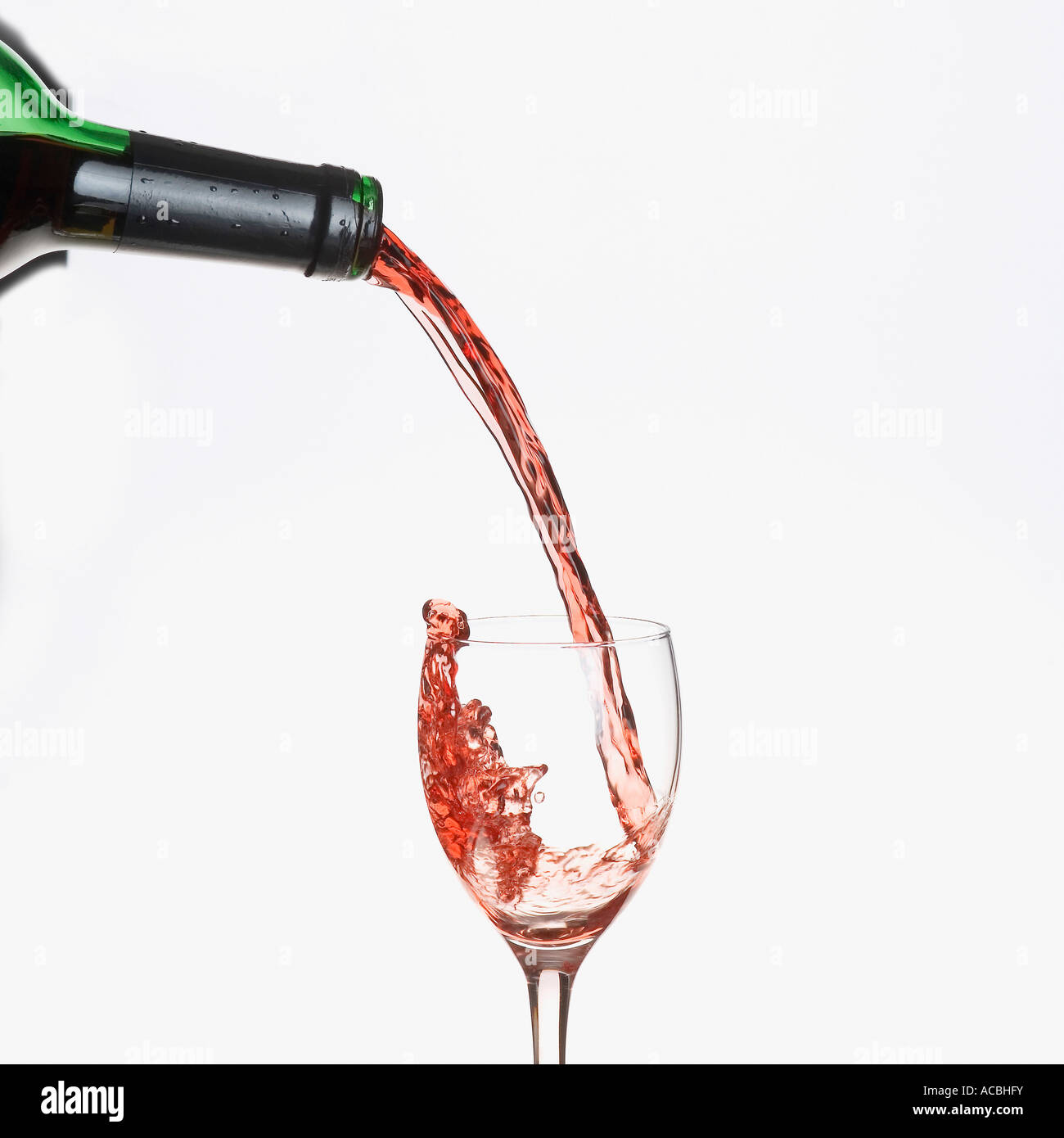 Red wine pouring from a bottle into a glass Stock Photo Alamy