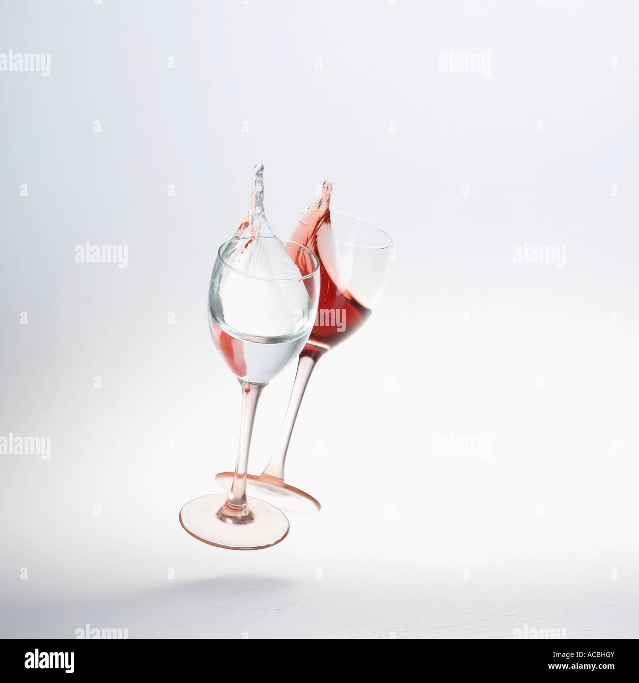 Close-up of wine spilling from two wine glasses Stock Photo