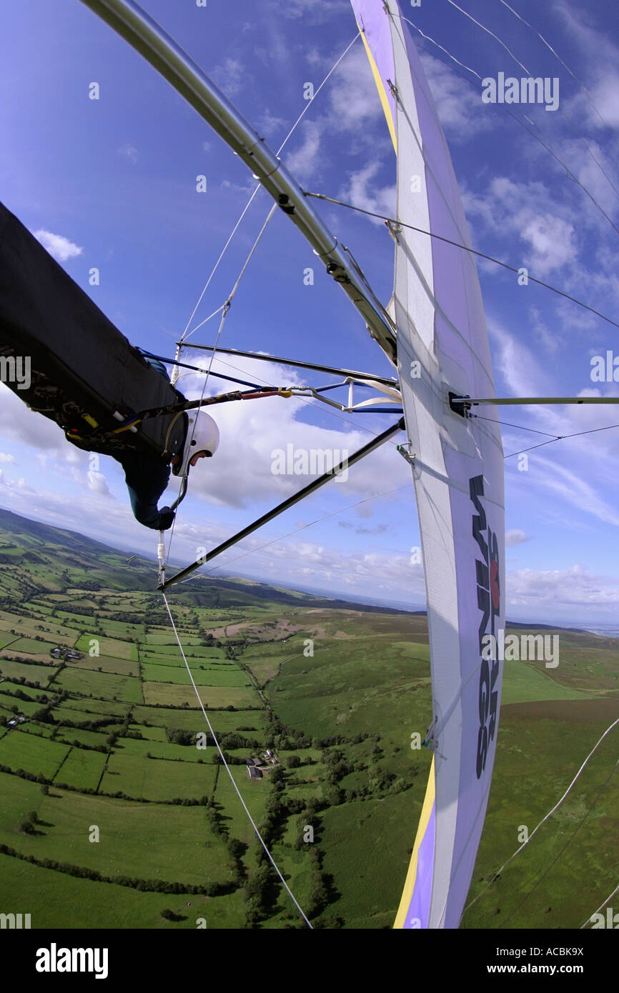 In flight shot of a hang glider in a steep turn over the Long Mynd
