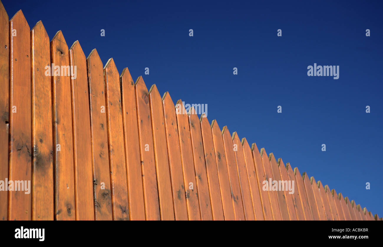 Wooden fence posts against deep blue sky Stock Photo Alamy