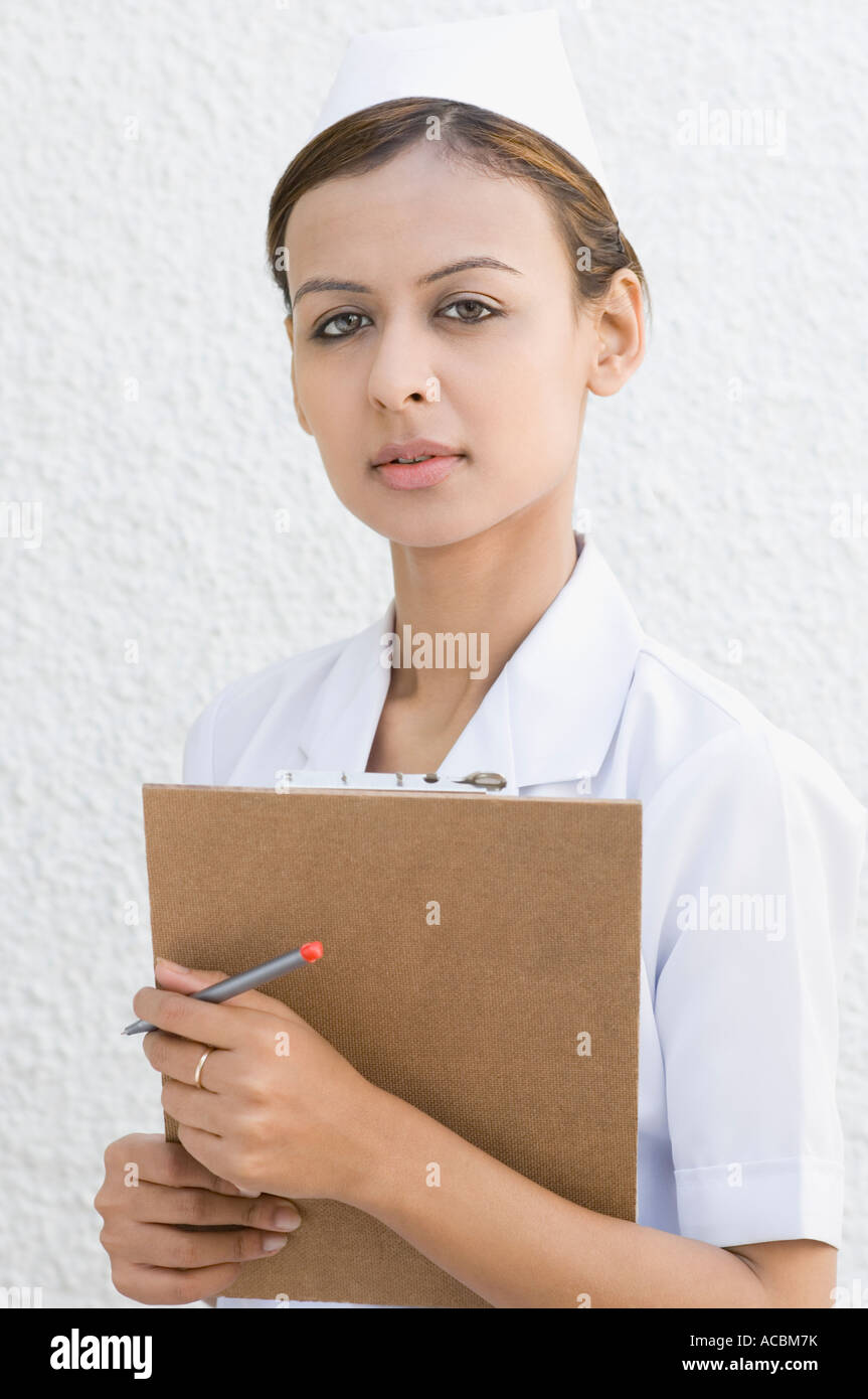 Portrait of a female nurse holding a clipboard Stock Photo - Alamy