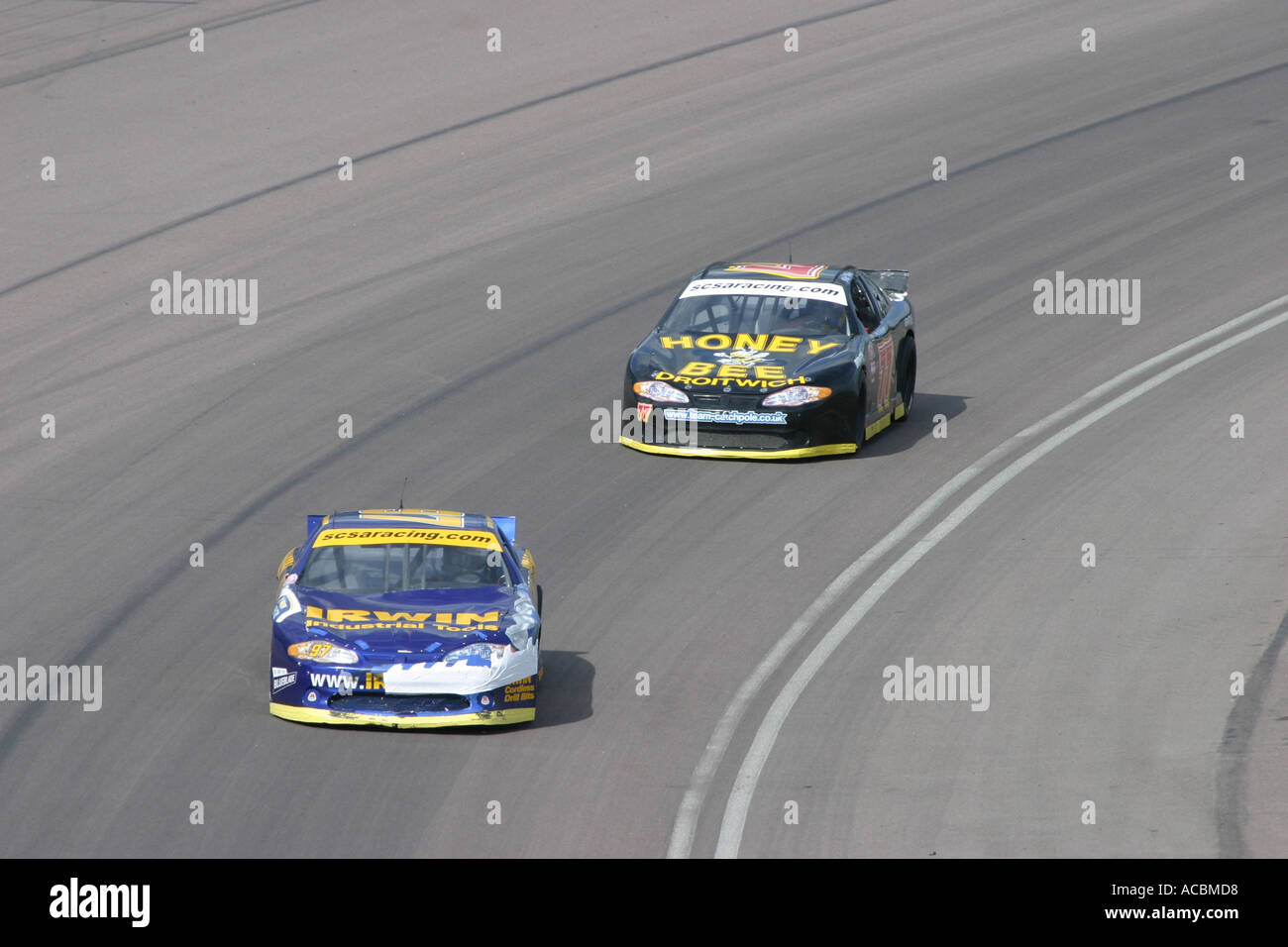 V8 Nascar type stock cars racing on a banked oval circuit Stock Photo ...