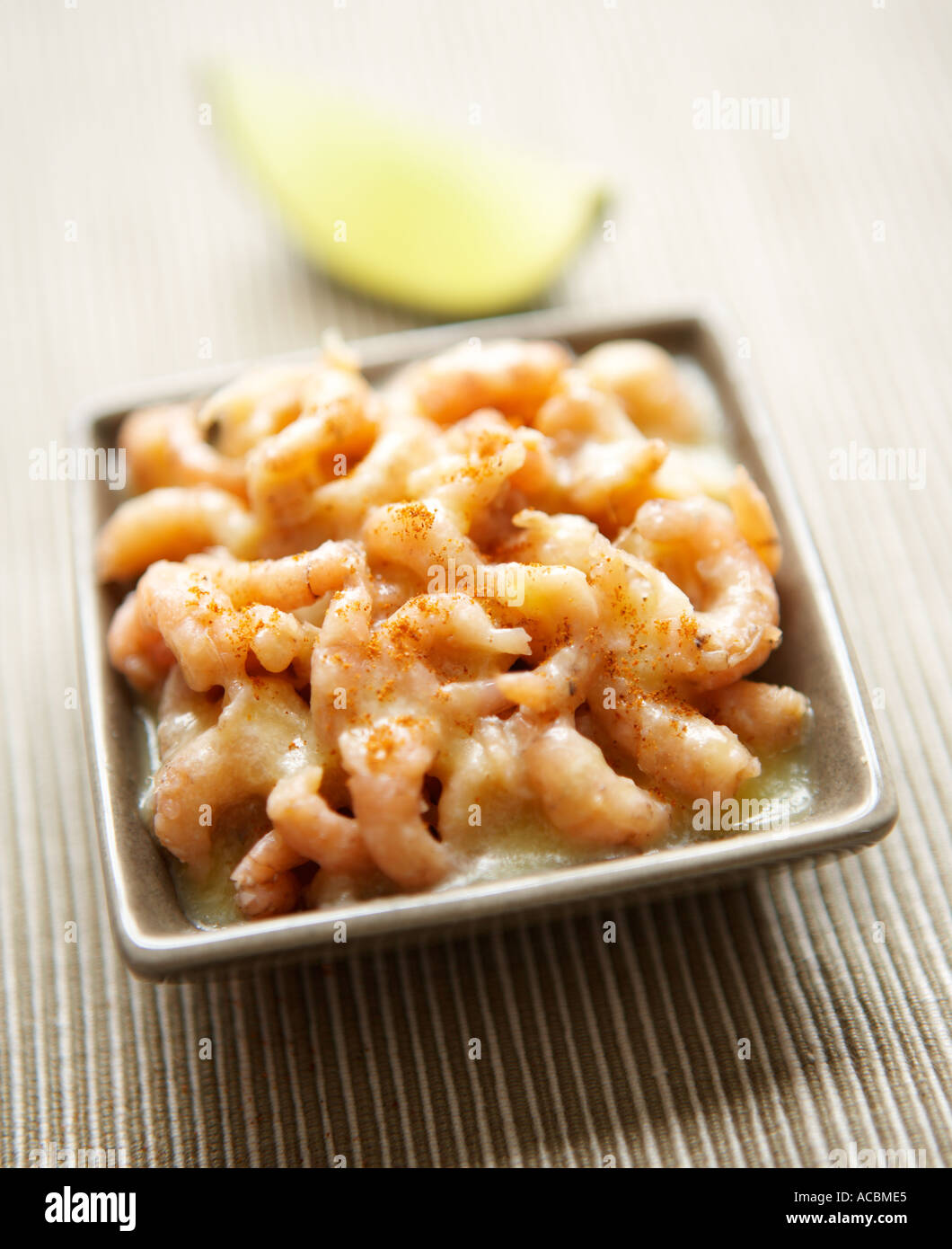 Potted Shrimps in a square dish with a wedge of Lime Stock Photo